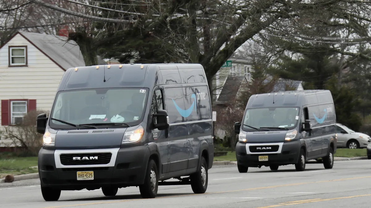 Amazon vans are shown delivering packages on March 30, 2020 in Hicksville, New York.