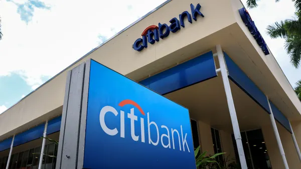 A blue sign at ground level reads "Citibank." The beige building next to it also has "Citibank" signage.