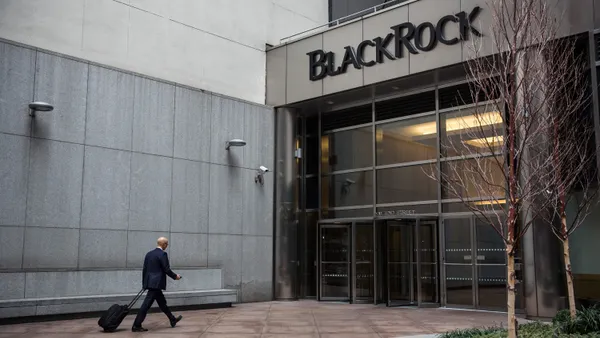 A man walks into a BlackRock office building.