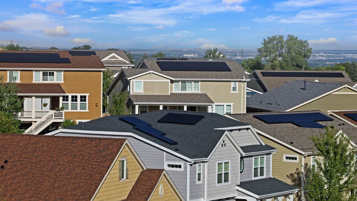 House with rooftop solar panels.