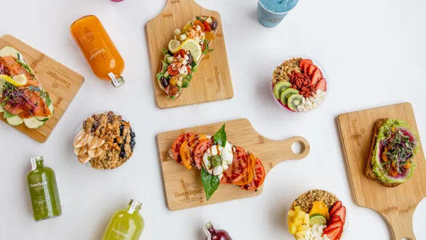 Toast, juice and bowls spread out against a white background.