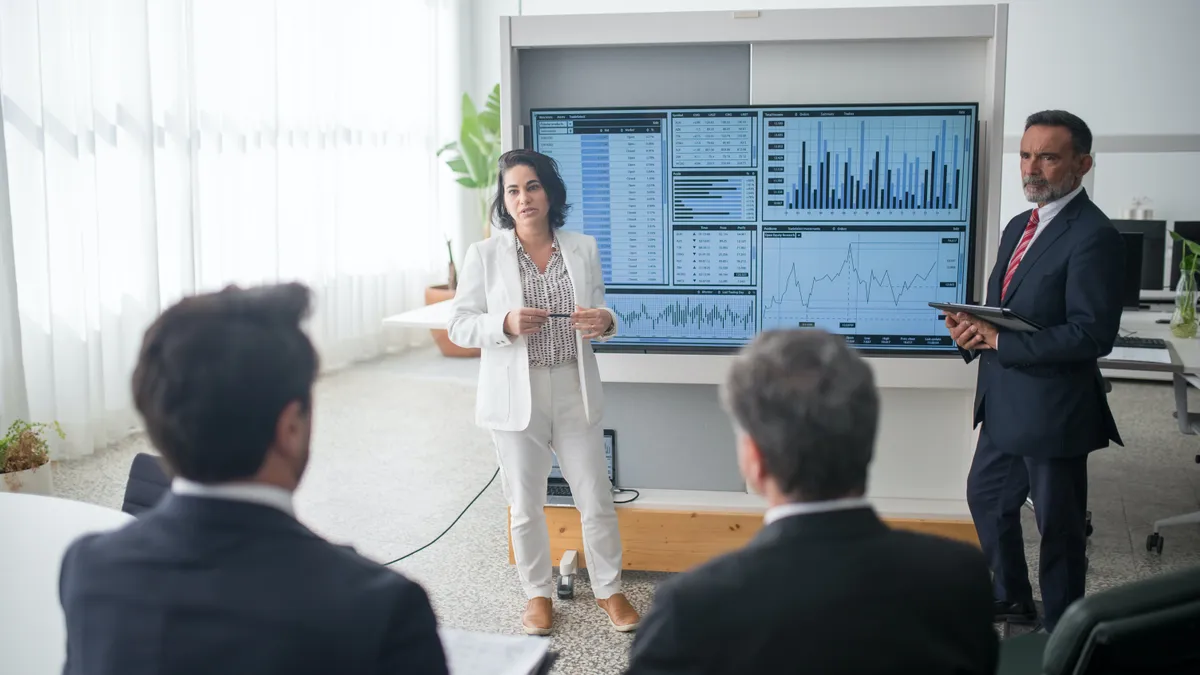 Man and Woman Presenting at Work