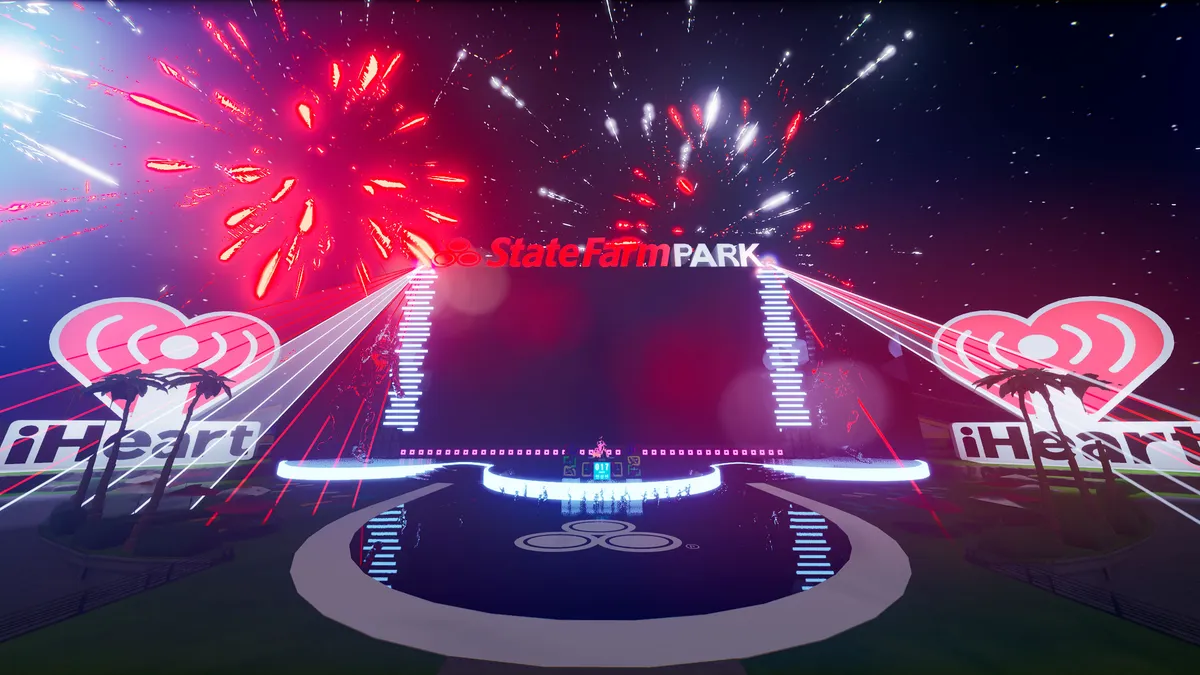 A large digital screen in the game Fortnite bears the signage State Farm Park while fireworks go off in the background.