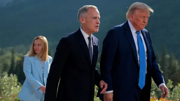 Canadian Prime Minister Mark Carney (center) and U.S. President Donald Trump (right) walk together during the G7 Leaders' Summit on June 16, 2025, in Kananaskis, Alberta. Italian Prime Minister Giorgia Meloni walks behind Carney and Trump.