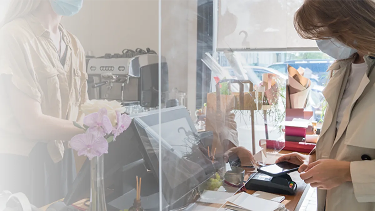 Woman Wearing Mask Paying At Floristic Studio