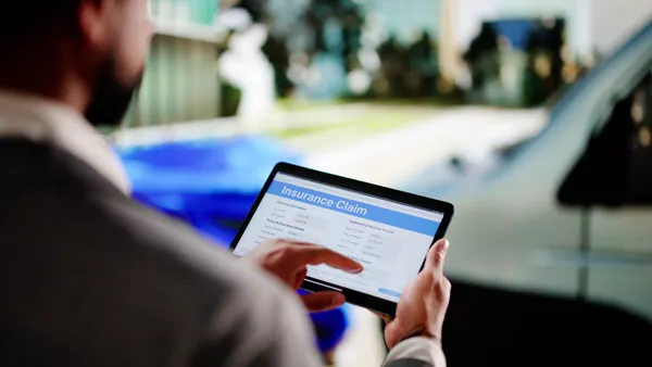 Black Insurance Expert Evaluating Vehicle Damage After Car Accident Claim