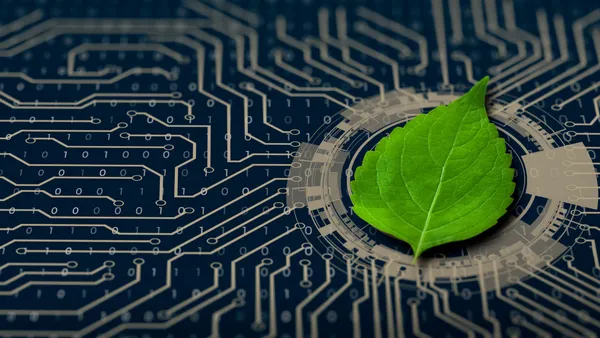 Green leaf on the converging point of computer circuit board.