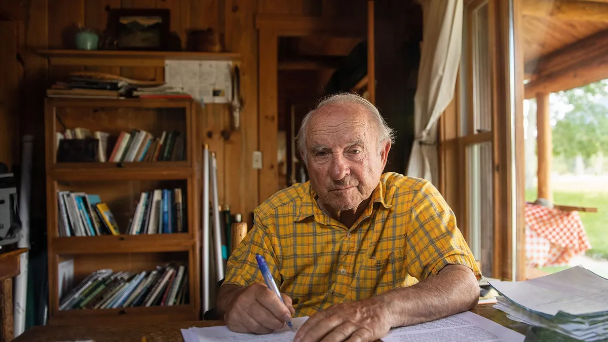 Patagonia founder Yvon Chouinard sits at a desk.