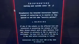A screenshot of a message from ShinyHunters on a laptop screen.