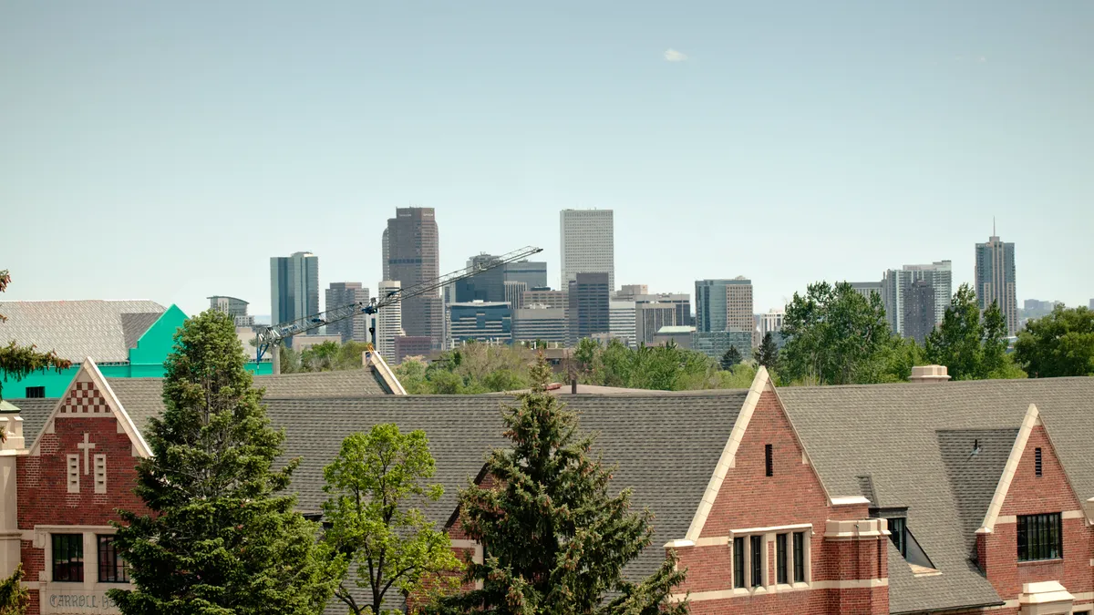 Neighborhood overlooking city skyline.