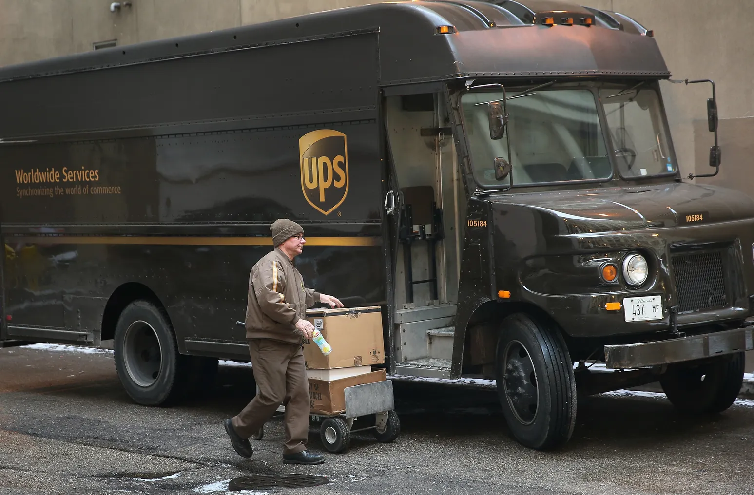 A UPS worker delivers packages on December 26, 2013 in Chicago, Illinois.