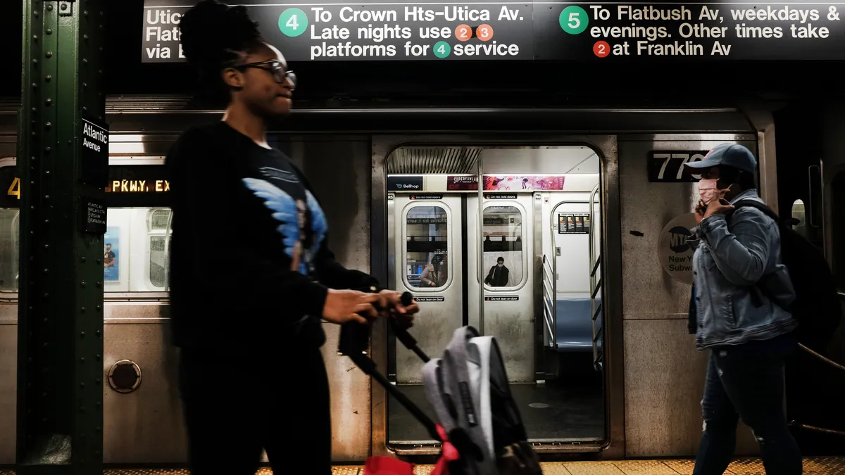 People walk through a Brooklyn subway station.