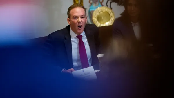 A man speaks at a table.