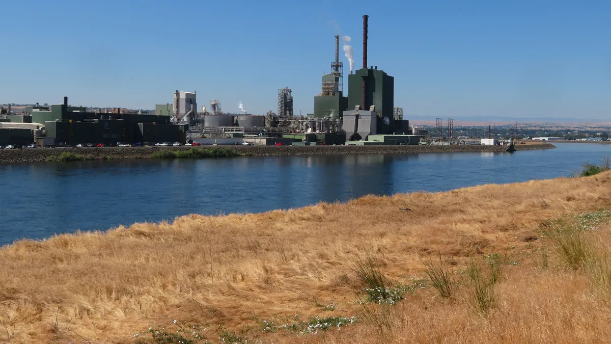 An industrial campus located along a body of water.