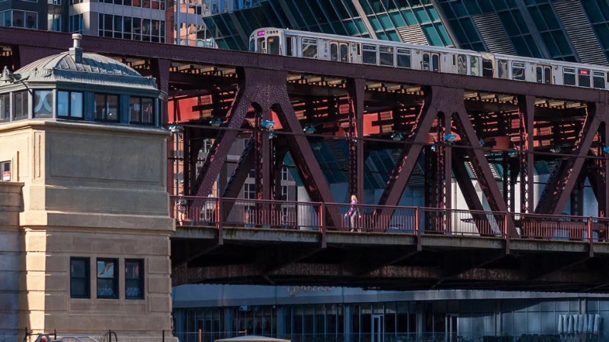 A wide shot from a distance of a metal bridge that stretches across the image.