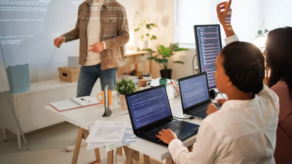 two workers in a technology education classroom