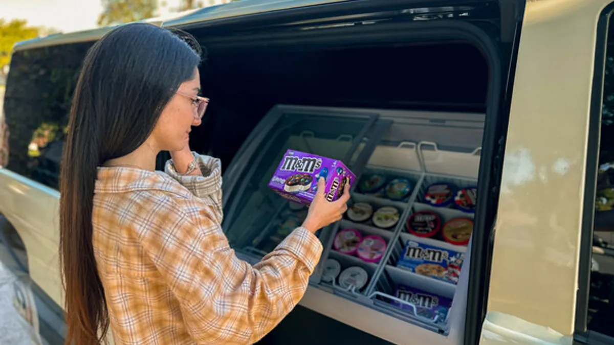 Girl picking out ice cream from Conjure mobile market truck