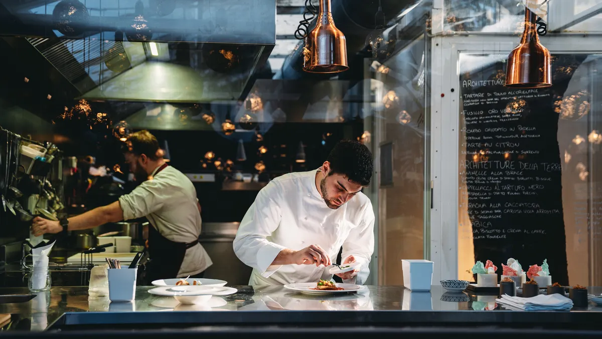 A chef is cooking in his restaurant's kitchen
