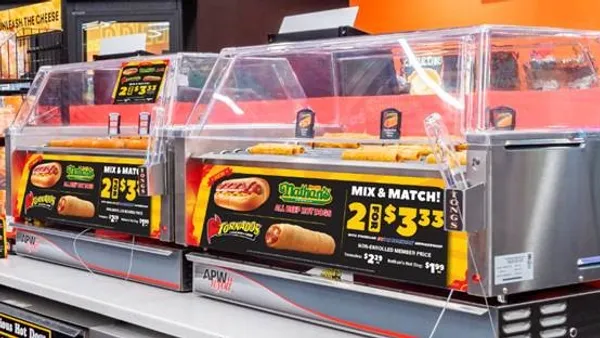 A photo of hot dogs on a roller grill inside a convenience store. The from of the grill has a Nathan's logo and says "mix and match 2 for $3.33"