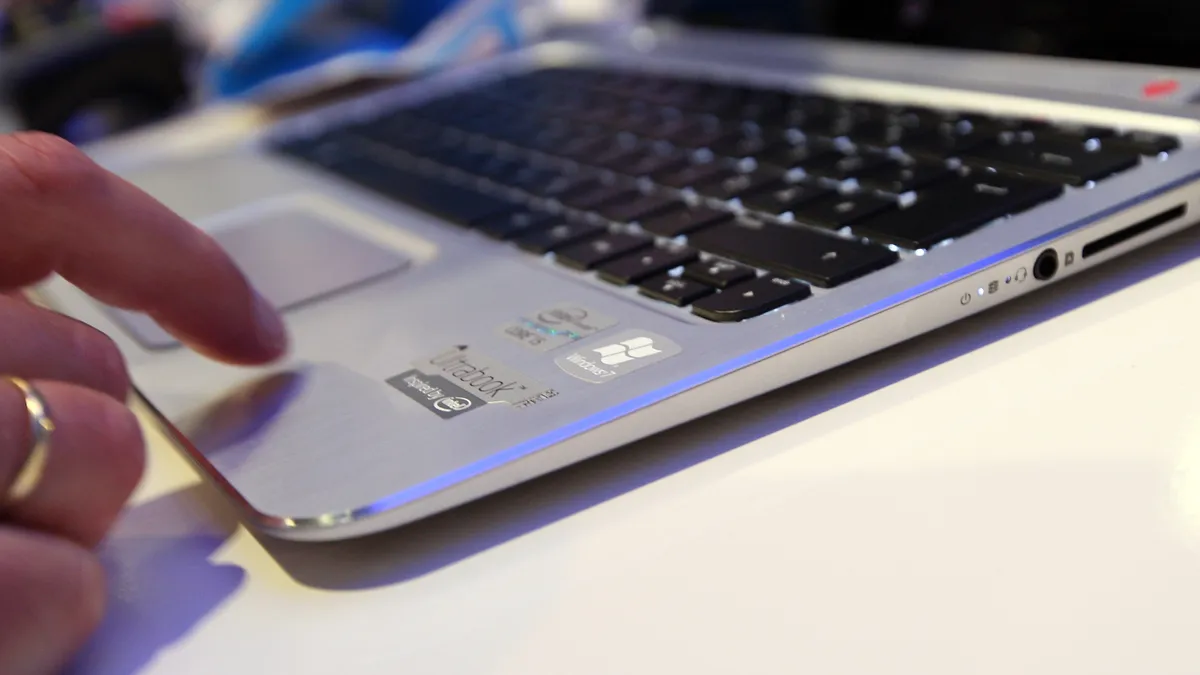 Hands next to a computer