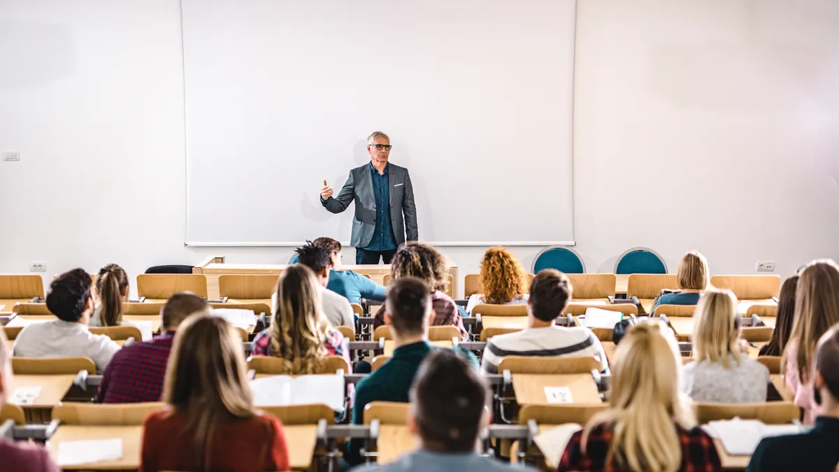 A college faculty member lectures to a class.