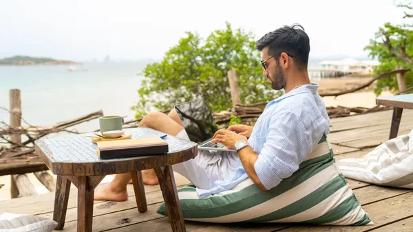 A traveler looks at a mobile device.