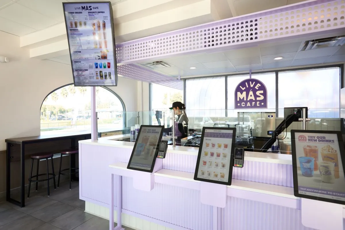 A close up look at a digital beverage menu and kiosks at Taco Bell&#x27;s Live Mas Cafe