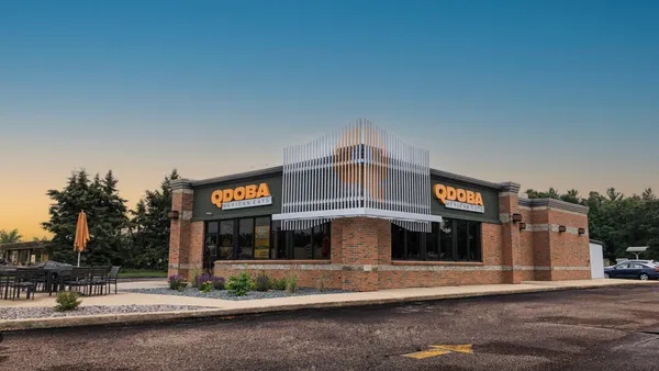 A Qdoba store around dusk.