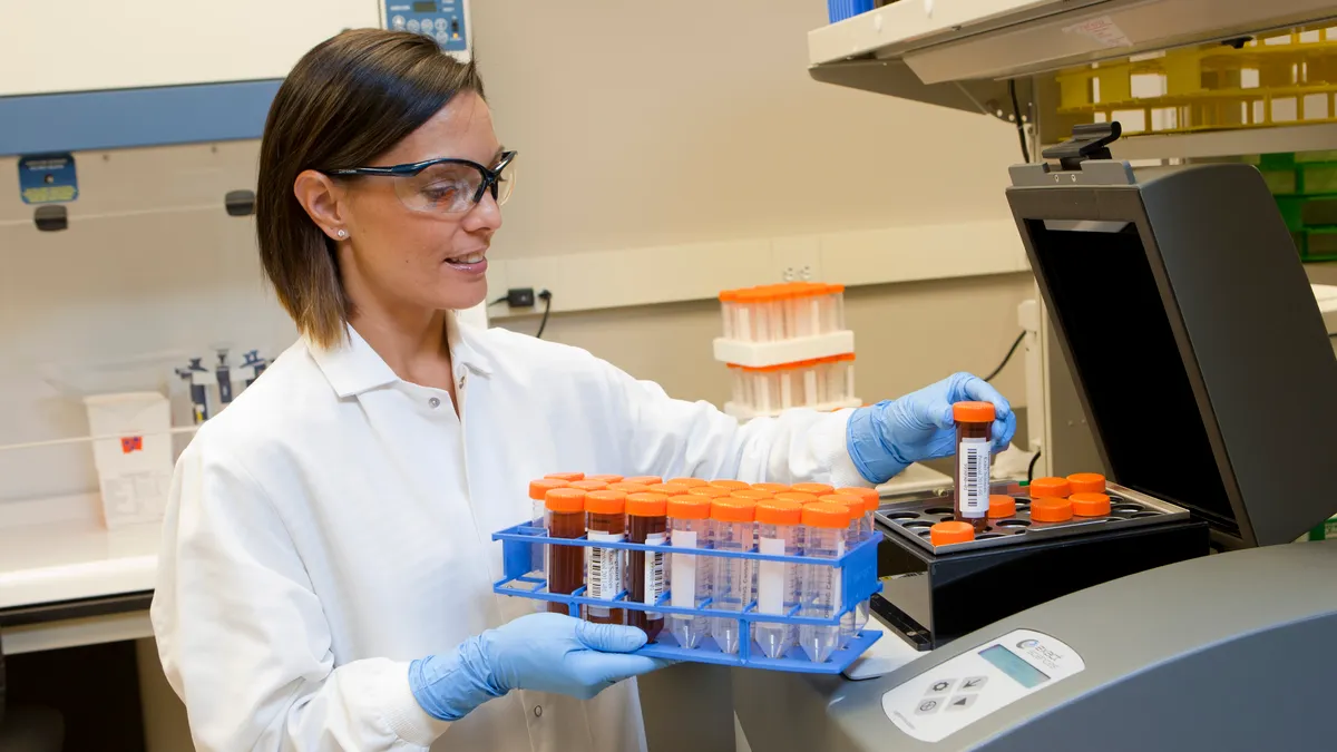 Senior Research Associate Tanya Quint loads one of the instruments used to run Exact Sciences' Cologuard test at the company's headquarters in Madison, Wis. (Photo: Business Wire)