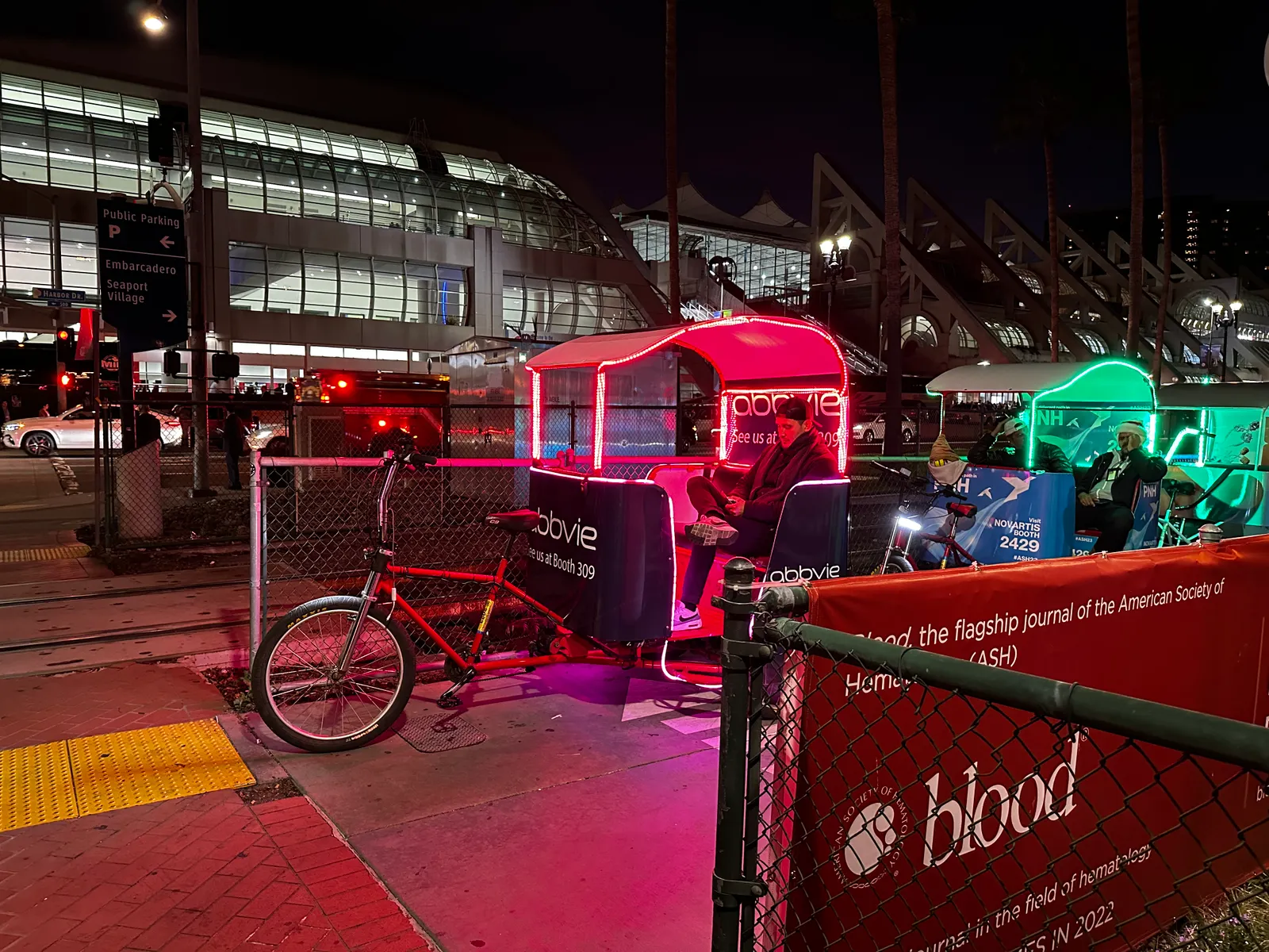 A line of pedicabs, with advertising by pharmaceutical companies, outside the San Diego Convention Center.