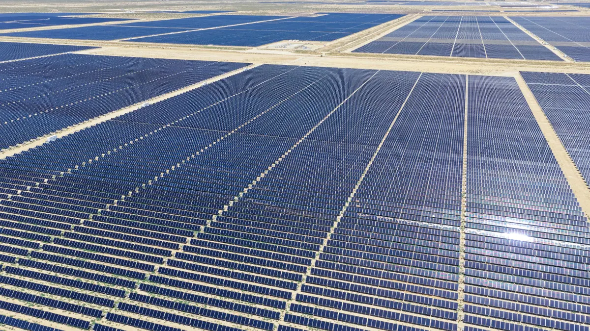 A large solar panel array in a desert landscape
