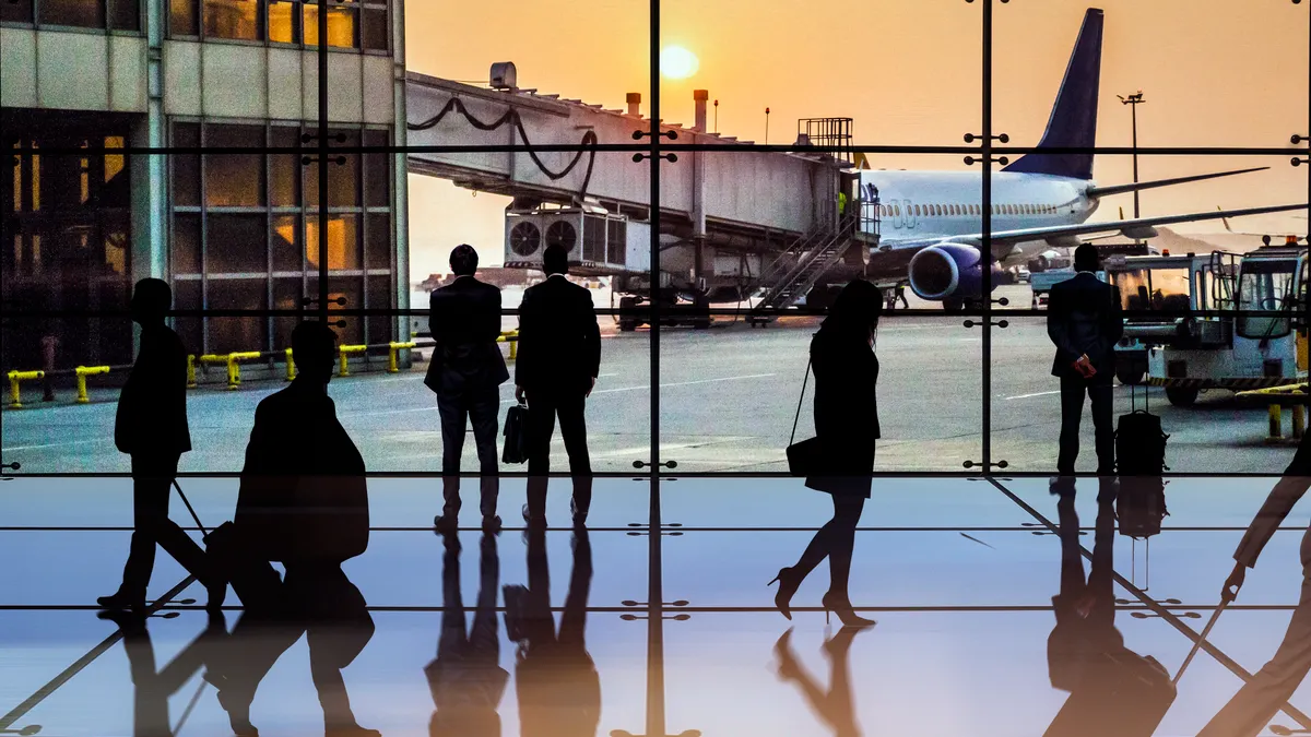 Busy airport terminal at sunset