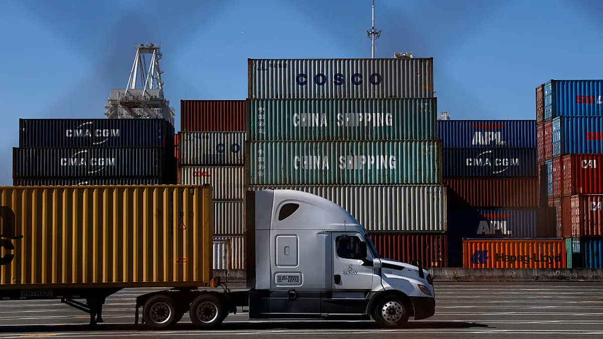 A truck drives through a port in Oakland, California.