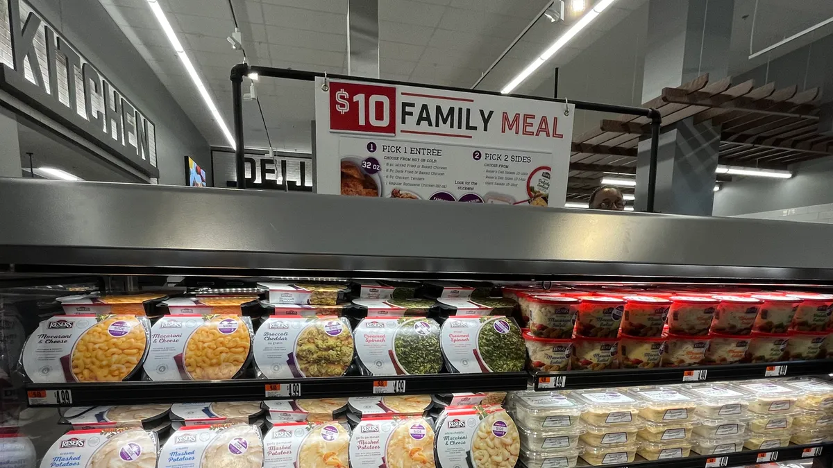 A $10 family meal deal display at a grocery store.