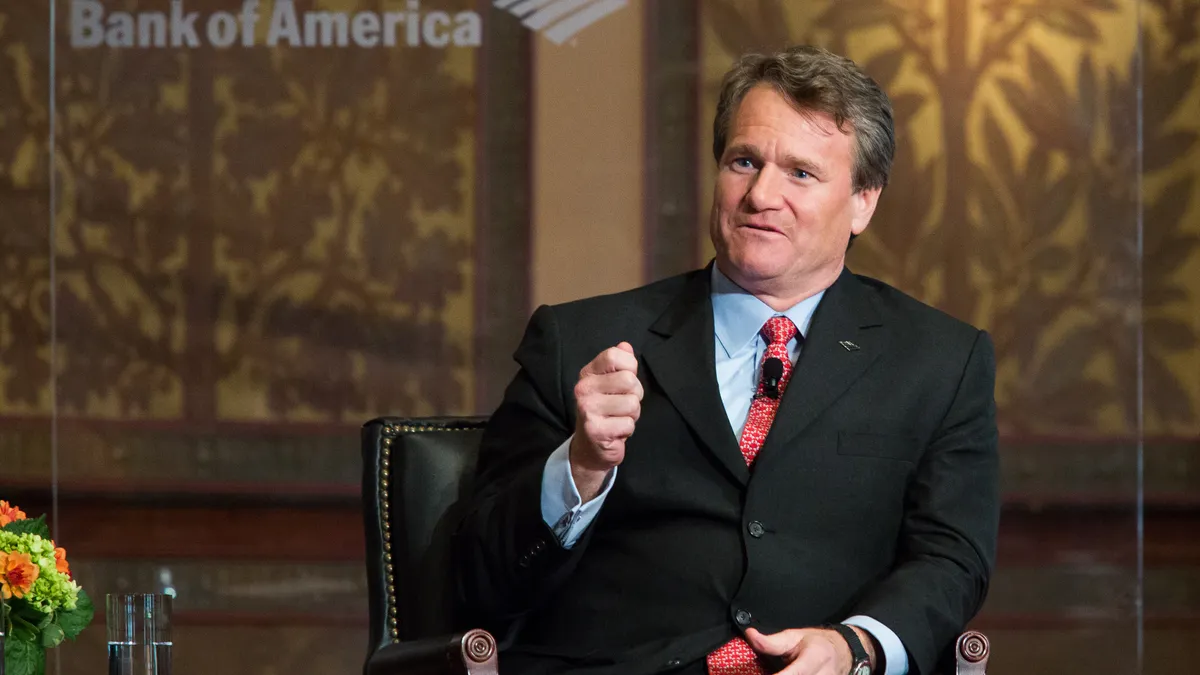 Bank of America CEO Brian Moynihan moderates a discussion while seated onstage.