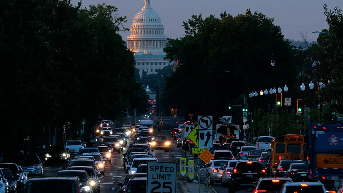 The U.S. Capitol stands in the distance as morning traffic moves along North Capitol Street Northwest on October 01, 2025 in Washington, DC. The government shut down early Wednesday after Congress failed to reach a funding deal.