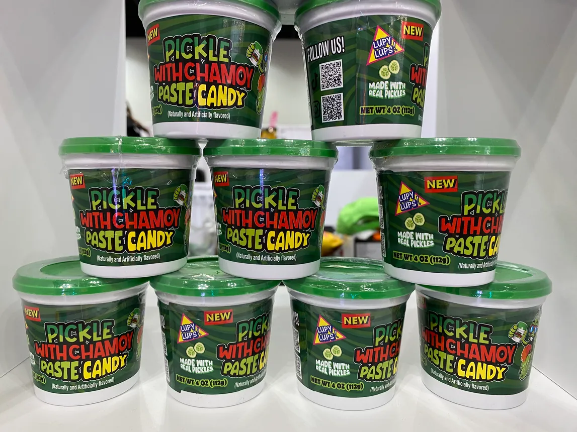 Packages of sauces, spices and candy made with pickles and chamoy at the Sweets &amp; Snacks Expo in Indianapolis in 2024.