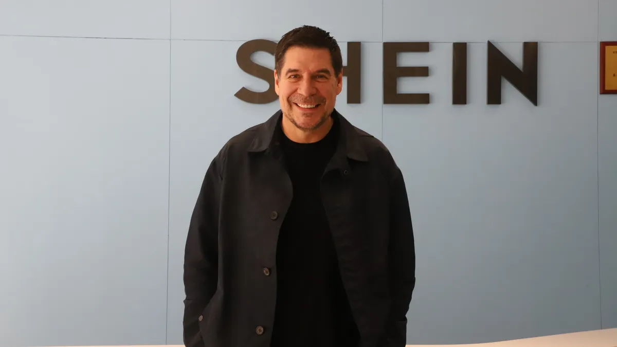 Marcelo Claure stands for a professional headshot with the Shein logo in the background.