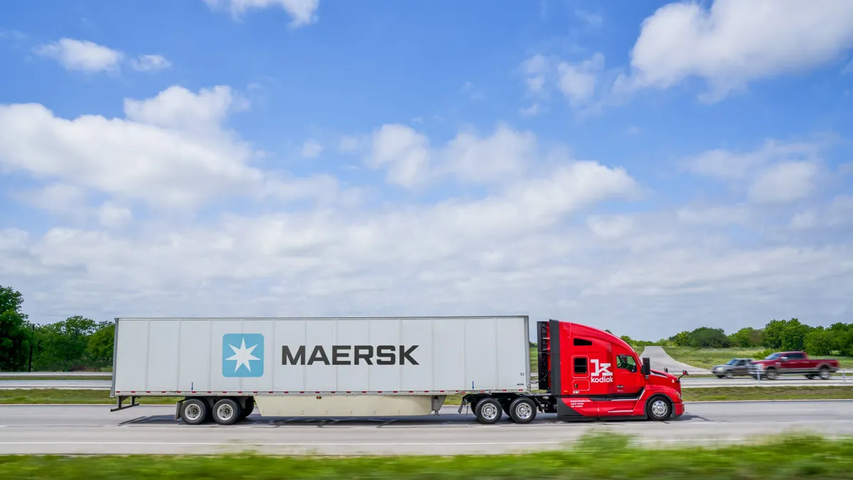 A Kodiak autonomous truck hauls a Maersk container.