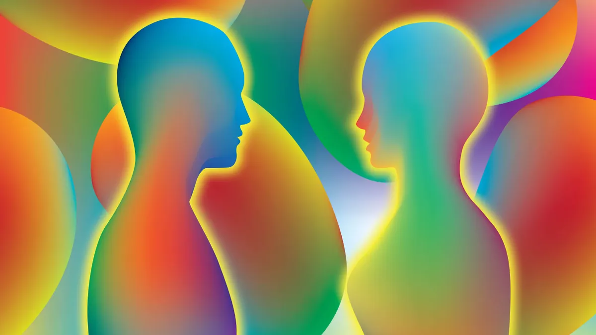 Silhouettes of two people colored in a swirling spectrum of colors. They are against a background of other spectrum colors and shapes.