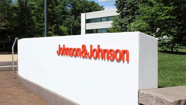 A wall bearing the Johnson & Johnson logo is seen outside of an office building.
