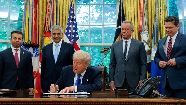 U.S. President Donald Trump, accompanied by Food and Drug Administration Commissioner Marty Makary (L), National Institutes of Health Director Jayanta Bhattacharya (2nd-L), Health and Human Services Secretary Robert F. Kennedy Jr. (2nd-R) and Domestic Policy Council Director Vince Haley (R), signs an executive order in the Oval Office at the White House on May 05, 2025 in Washington, DC