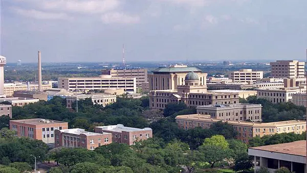 Campus buildings seen from a football stadium.