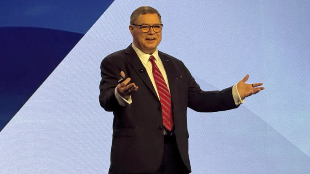 Analyst gene alvarez speaks on stage