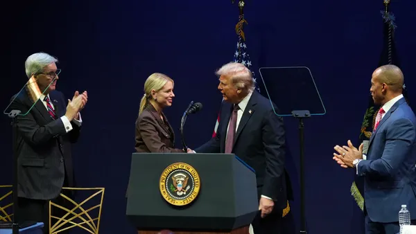 U.S. Attorney General Pamela Bondi and President Donald Trump shake hands
