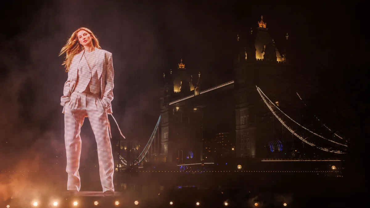 A view of a hologram of model Gisele Bündchen in from of the London Bridge.