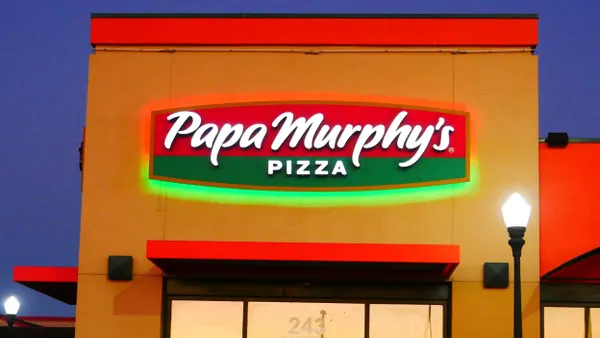 An evening image of a building that says Papa Murphy's