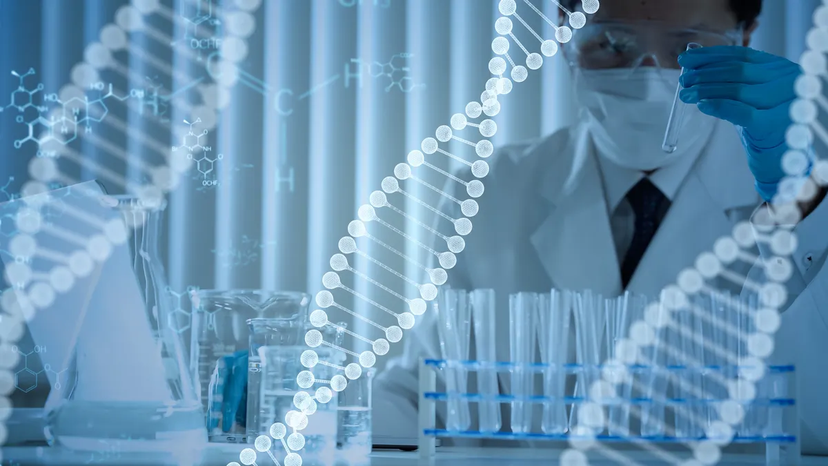 A man looks at a glass test tube in a lab, with beakers and additional tubes on a surface in front of him. Overlaid on the image are strands of double-helix DNA and chemistry diagrams.