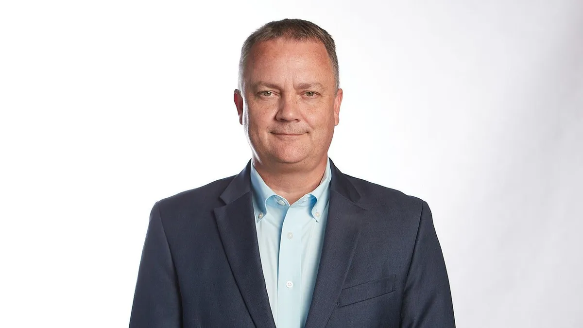 Darren Hawkins, former Yellow CEO, smiles in a corporate headshot.