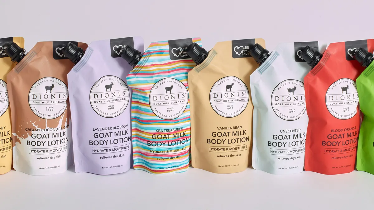 A variety of different colored pouches of Dionis Goat Milk Skincare lotion.